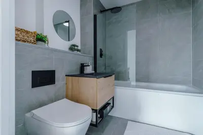 a bathroom with a toilet and a sink and a tub at Stunning 2-Bed Premium Apartment - Free WI-FI in Preston