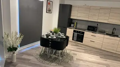 a kitchen with a table with cups on it at Stunning 2-Bed Premium Apartment - Free WI-FI in Preston