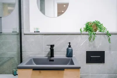 a bathroom sink with a soap dispenser on it at Luxury King Size 1-Bed City Apartment - Free WI-FI in Preston