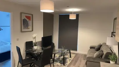 a living room with a couch and a table at Luxury King Size 1-Bed City Apartment - Free WI-FI in Preston