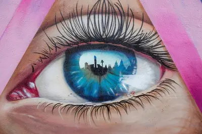 an eye with a reflection of a city in the pupil at Camden Apartments 1 in Liverpool