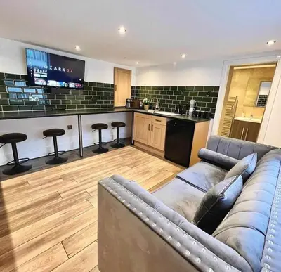 a living room with a couch and a kitchen at Camden Apartments 1 in Liverpool