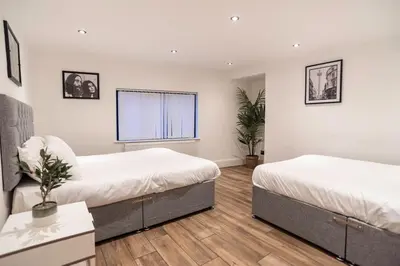 a bedroom with two beds and a window at Camden Apartments 2 in Liverpool