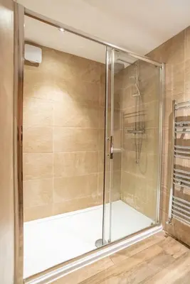 a shower with a glass door in a bathroom at Camden Apartments 2 in Liverpool
