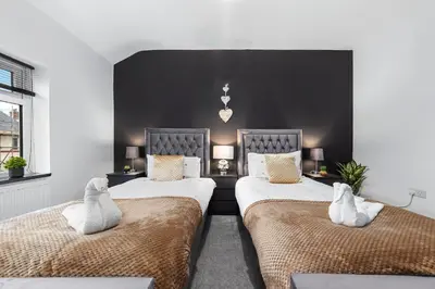 a bedroom with two beds with white pillows at 2 Bed Flat - Sleeps 8 - Pets - Parking - Wifi in Blackpool