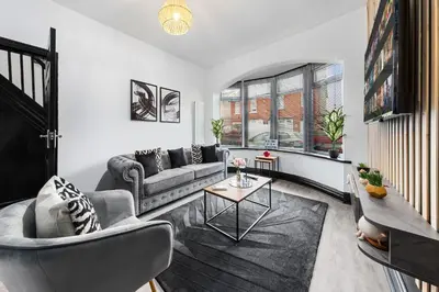 a living room with a couch and a table at 2 Bed Flat - Sleeps 8 - Pets - Parking - Wifi in Blackpool