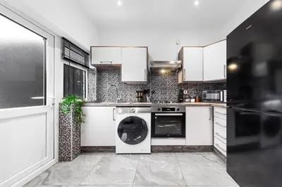 a kitchen with a washer and dryer in it at 2 Bed Flat - Sleeps 8 - Pets - Parking - Wifi in Blackpool