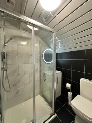 a bathroom with a shower and a toilet at Granada Apartments Holmfield Rd in Blackpool