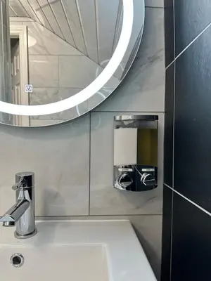 a bathroom with a sink and a mirror at Granada Apartments Holmfield Rd in Blackpool