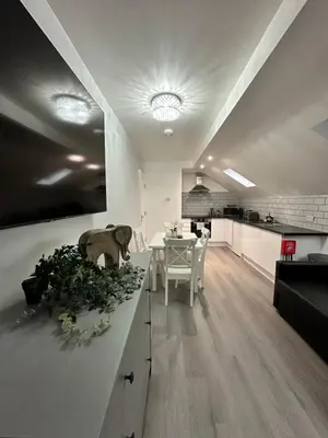 a kitchen and living room with a table and chairs at Granada Apartments Holmfield Rd in Blackpool
