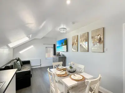 a living room with a table and a couch at Granada Apartments Holmfield Rd in Blackpool