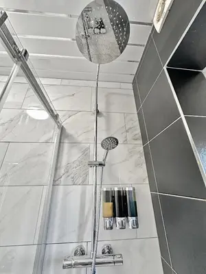 a shower in a bathroom with a shower head at Granada Apartments Holmfield Rd in Blackpool