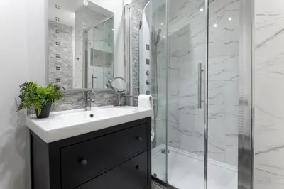 a bathroom with a sink and a shower at Flatzy - 3 Bedroom Apartment in Heart of City Centre in Liverpool