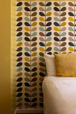 a bedroom with a wall with colorful patterns on it at Flatzy - 3 Bedroom Apartment in Heart of City Centre in Liverpool
