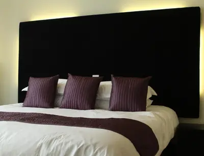 a large bed with purple pillows on top of it at Liver View Apartments in Liverpool