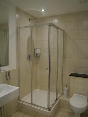a bathroom with a shower with a toilet and a sink at Liver View Apartments in Liverpool