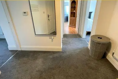 a hallway with a mirror and a trash can at CLITHEROE TOWN CENTRE MODERN 2 BED APARTMENT in Clitheroe