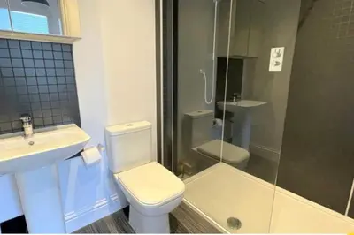 a bathroom with a toilet and a sink and a shower at CLITHEROE TOWN CENTRE MODERN 2 BED APARTMENT in Clitheroe