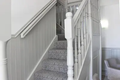 a staircase with a gray and white patterned carpet at Rufford Arms Hotel in Rufford