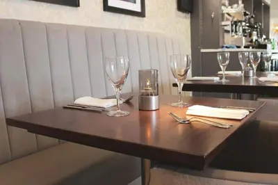 a wooden table with wine glasses on top of it at Rufford Arms Hotel in Rufford