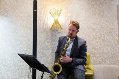 a man playing a saxophone next to a laptop at Rufford Arms Hotel in Rufford