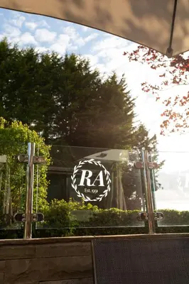 a reflection of a sign in a glass window at Rufford Arms Hotel in Rufford