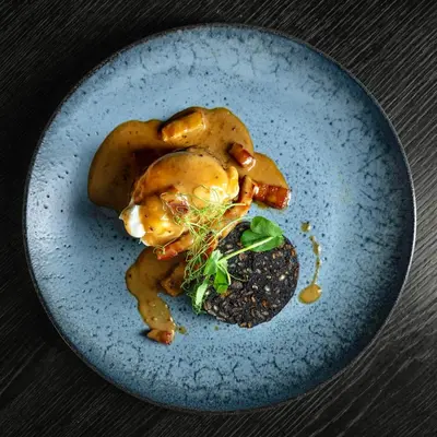 a blue plate with food on a table at Foxfields Country Hotel in Langho