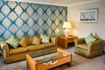 a living room with a couch and two chairs at Foxfields Country Hotel in Langho