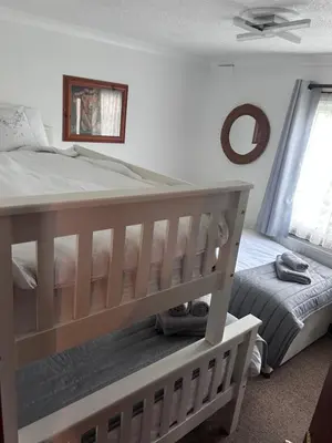 a bedroom with a large bed and a crib at Sunshine Lodge Haven Lakeland in Flookburgh