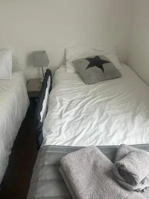 a bed with two towels on it in a room at Sunshine Lodge Haven Lakeland in Flookburgh