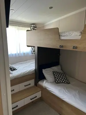 two bunk beds are in a small room at Blissful Lodge Haven Lakeland in Flookburgh
