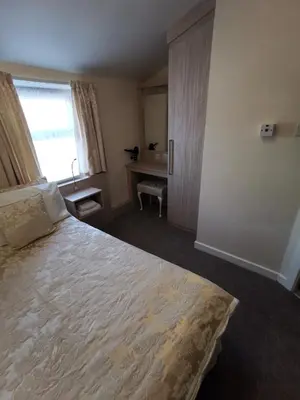 a bedroom with a large bed and a window at The Stafford in Blackpool