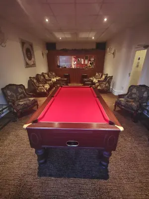 a pool table in a living room with couches at The Stafford in Blackpool