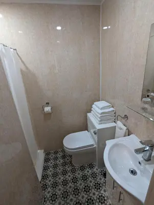 a bathroom with a toilet and a sink at The Stafford in Blackpool