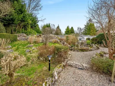 a garden with a light in the middle at The Cottage At Breeze Hill in Storth