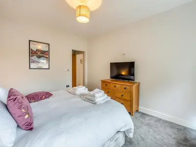 a bedroom with a bed and a tv on a dresser at The Cottage At Breeze Hill in Storth