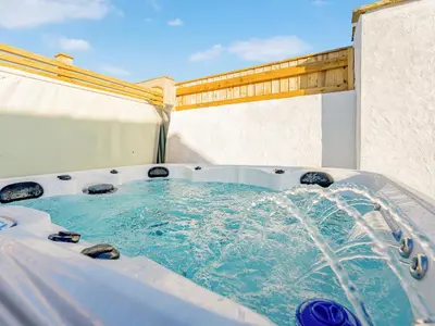 a hot tub with water coming out of it at The Hideaway in Great Meols