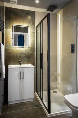 a bathroom with a shower and a sink and a toilet at The Charleston in Blackpool