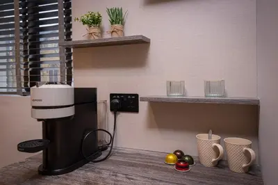 a coffee machine sitting on a counter with fruits and cups at The Charleston in Blackpool
