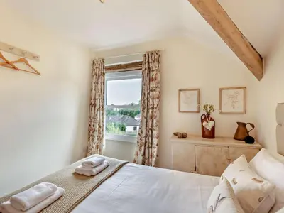 a bedroom with a bed and a window at 2 Bed in Grange-over-sands oc-73544 in Grange Over Sands