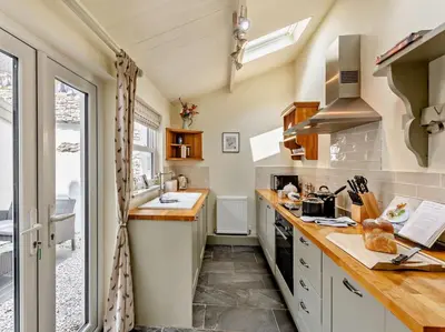 a small kitchen with a sink and a stove at 2 Bed in Grange-over-sands oc-73544 in Grange Over Sands