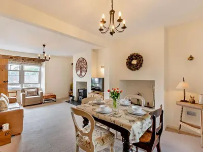 a dining room with a table and chairs and a living room at 2 Bed in Grange-over-sands oc-73544 in Grange Over Sands