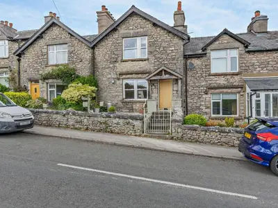 two cars parked in front of a stone house at 2 Bed in Grange-over-sands oc-73544 in Grange Over Sands