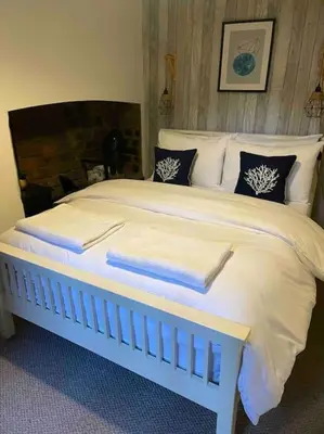 a white bed with two towels on top of it at City Centre Georgian Qtr Apartment Canning St 2bed 2bath in Liverpool
