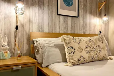 a bedroom with a bed with a wooden head board at City Centre Georgian Qtr Apartment Canning St 2bed 2bath in Liverpool