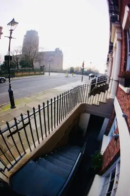 a staircase leading to a building with a fence at City Centre Georgian Qtr Apartment Canning St 2bed 2bath in Liverpool