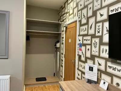 a room with a wall covered in pictures on the wall at Chequers Lodge- Dalton-in- Furness- Self check in- for professionals and tourists in Dalton in Furness