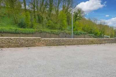 a stone wall with pigeons standing on the ground at Chequers Lodge- Dalton-in- Furness- Self check in- for professionals and tourists in Dalton in Furness