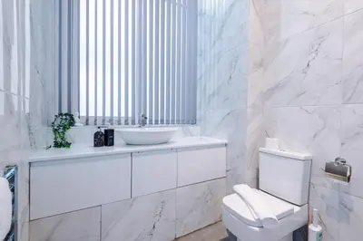 a white bathroom with a sink and a toilet at Modern 2-Bedroom Apt In the Heart of City Centre in Liverpool