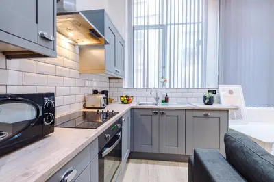 a kitchen with a sink and a microwave at Modern 2-Bedroom Apt In the Heart of City Centre in Liverpool